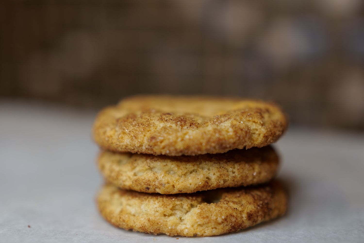 stack of snickerdoodle cookies on a white surface