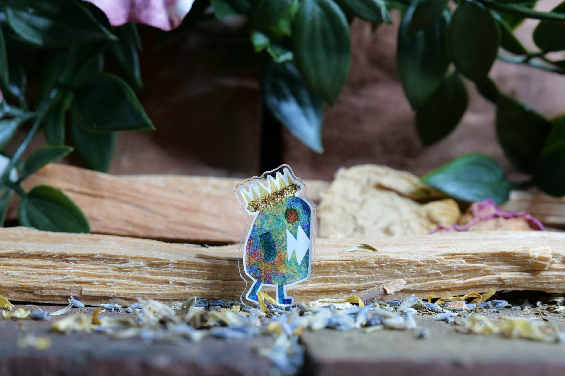 trump impeached...again acrylic pin on a wooden surface with plants and flowers in the background